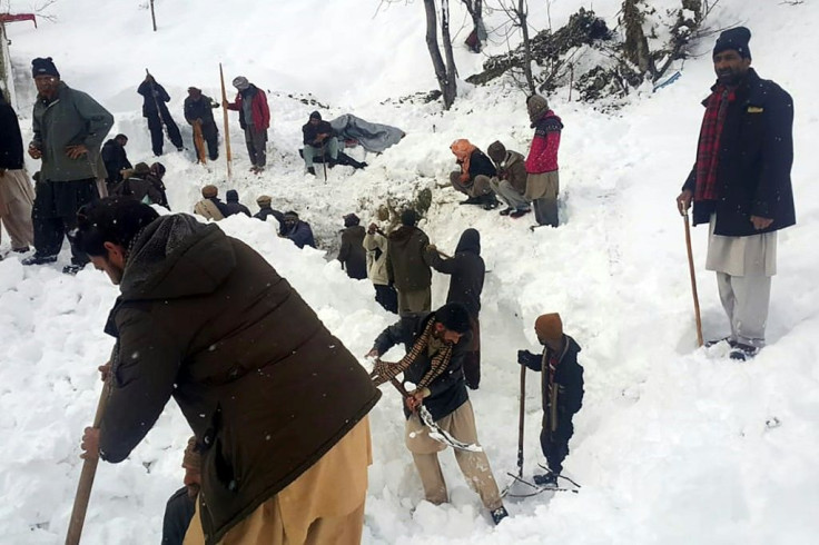 Local residents search for victims of an avalanche that hit the  Neelum Valley in Pakistan-administered Kashmir