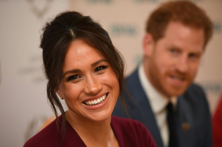 Britain's Prince Harry, Duke of Sussex (R) and Meghan, Duchess of Sussex