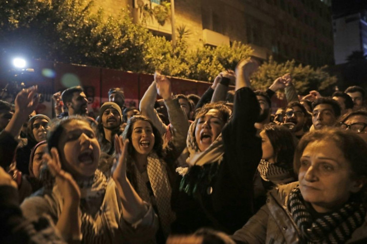 Lebanese demonstrators chant slogans against informal capital controls in front of the central bank in Beirut