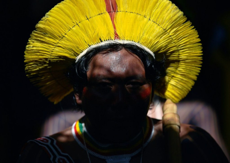 An indigenous tribesman listens to Metuktire during a press conference in Piaracu village, near Sao Jose do Xingu in Brazi's Mato Grosso state