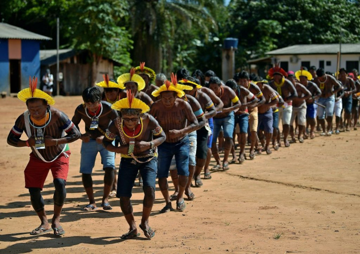 Indigenous tribesmen perform a dance at their gathering in Piaracu village on the banks of the Xingu river in the Amazon