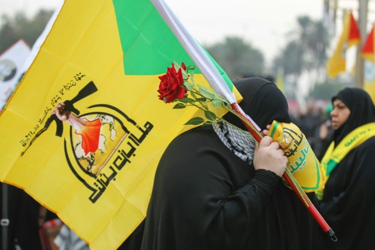 A supporter holding the flag of Hezbollah, which the UK government designated as a terror organisation