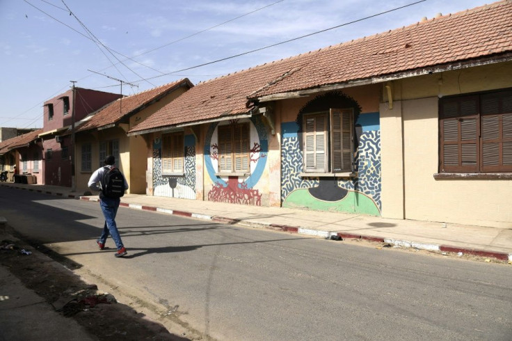 Painting the walls of old colonial buildings is meant to save them as developers move in