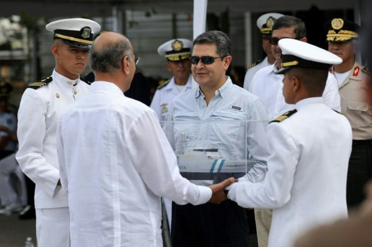 Honduran President Juan Orlando Hernandez (C), shown at the handover ceremony for a coastal patrol vessel bought from Israel, has dismissed as "absurd" accusations that he received bribes from drug lords