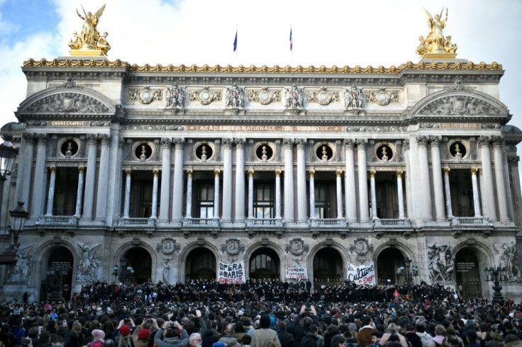Musicians perform in front of the Palais Garnier during a demonstration of striking employees