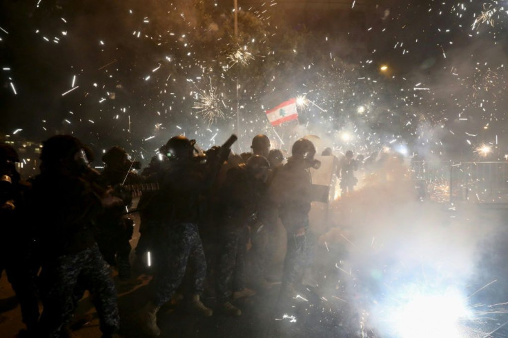 Lebanese security forces react to fireworks hurled  by anti-government protesters in downtown Beirut