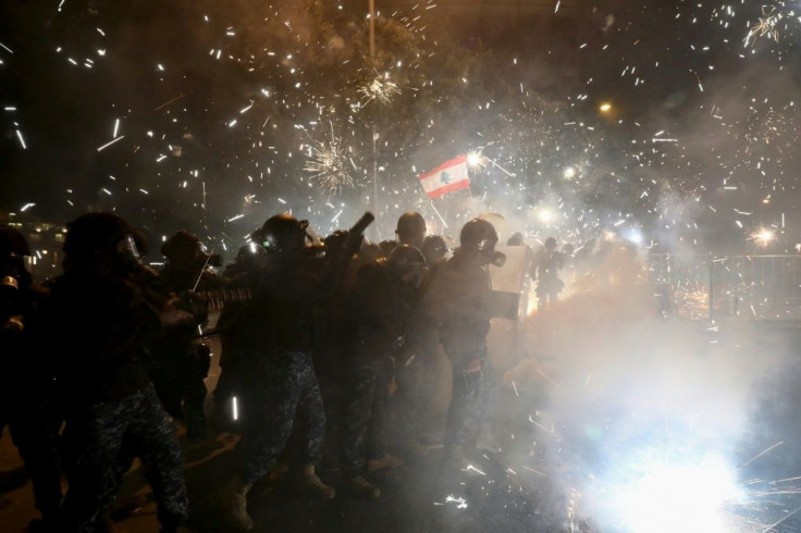 Lebanese security forces react to fireworks hurled by anti-government protesters in downtown Beirut