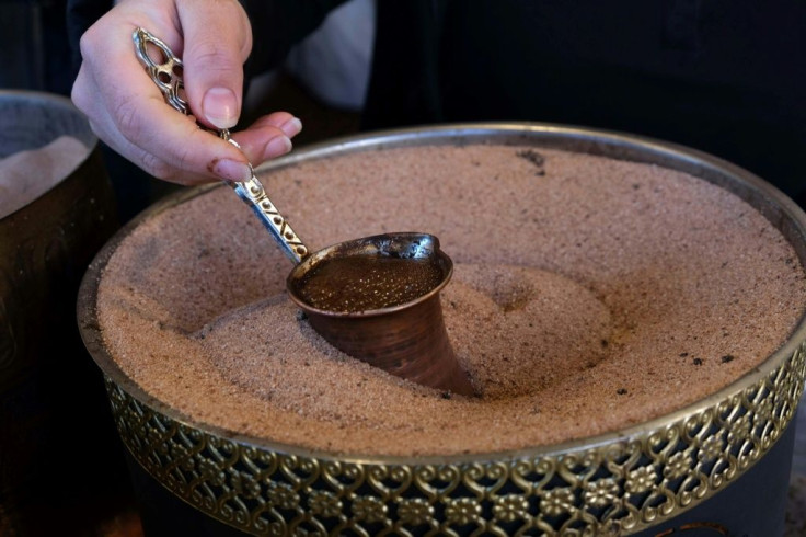 An Iraqi Kurdish woman prepares Syrian coffee in a shop in Arbil's central bazar