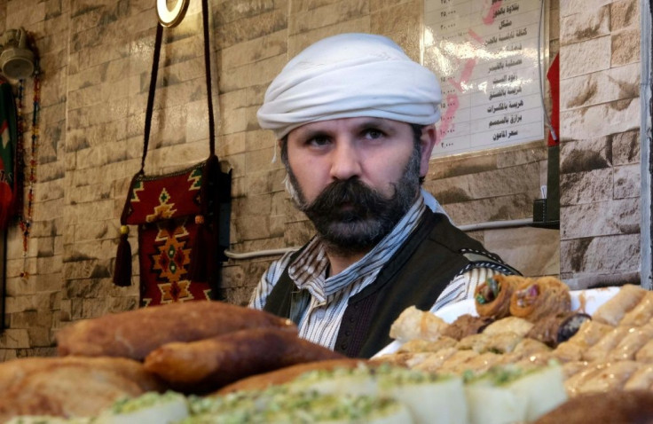 This Syrian Kurdish man sells sweets at a shop in Arbil