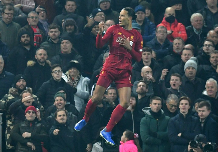 Towering clear: Virgil van Dijk's opening goal helped send Liverpool 16 points clear at the top of the Premier League