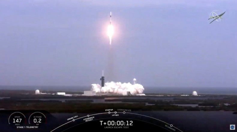 This NASA TV video frame grab shows a SpaceX rocket launching to perform an in-flight abort test of its Crew Dragon spacecraft, which was unmanned for the apparently successful test