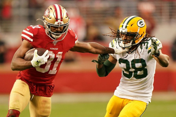 Raheem Mostert of the San Francisco 49ers blasts through the Green Bay defense