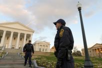 Virginia State police officers walk on the grounds of the State Capitol in Richmond, where security has been increased ahead of a pro-gun rights rally