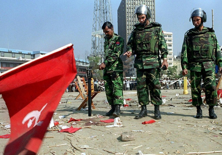 Bangladeshi soldiers inspect the scene of the 2001 bomb blast in Dhaka