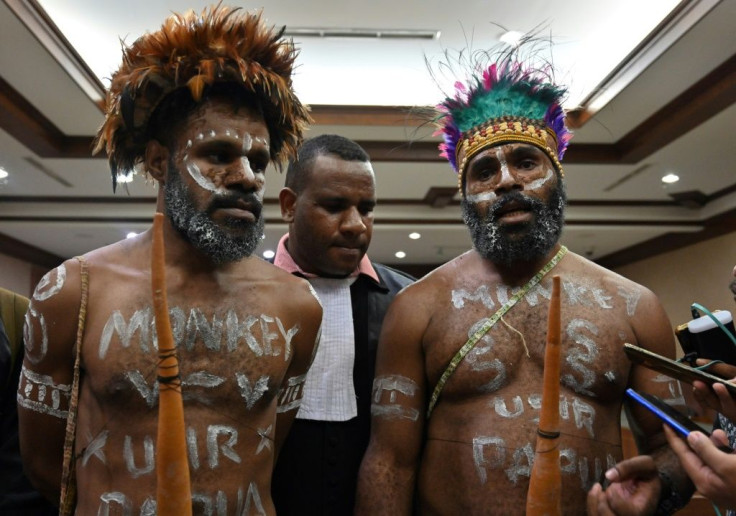 Papuan activists Ambrosius Mulait (left) and Dano Anes Tabuni speak to journalists during their trial in Jakarta
