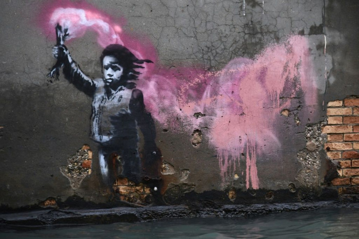 Street artist Banksy's work in Venice portraying a migrant child wearing a life jacket and holding a flare