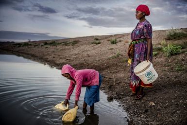Martha Kasafi and her daughter, refugees from Democratic Republic of Congo, collect water for their crops in Kalobeyei settlement for refugees in  Kenya on October 2, 2019; Independent experts on the Human Rights Committee issued a non-binding ruling in a