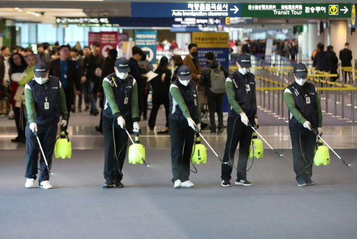 Cleaners spray disinfectant at Seoul's Incheon international airport after South Korea confirmed its first case of the SARS-like virus