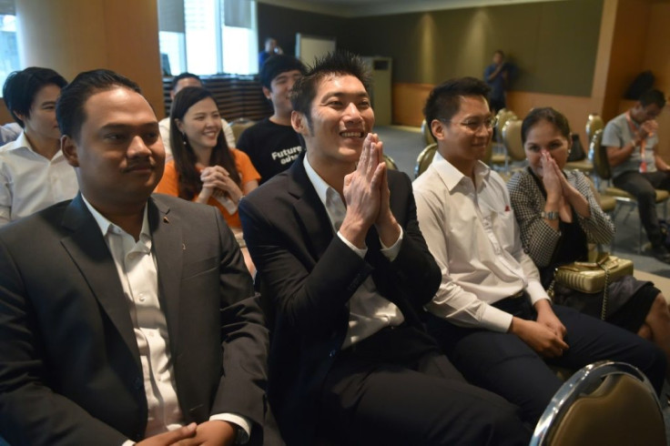 Thanathorn Juangroongruangkit, leader of the opposition Future Forward, gestures while listening to a live broadcast of the ruling on his party