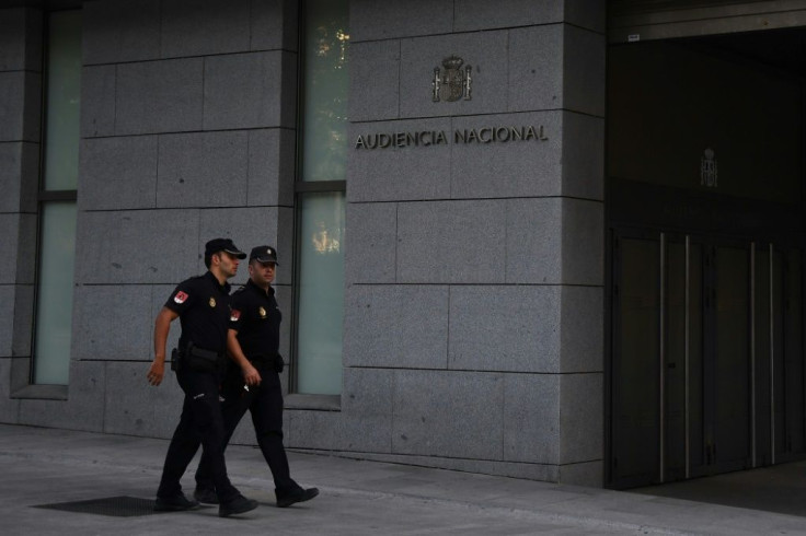 Spanih policemen walk in front of the National Court in Madrid