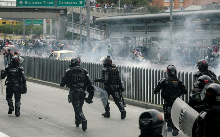 Riot police use tear gas to disperse demonstrators during anti-government protests in Bogota on Tuesday