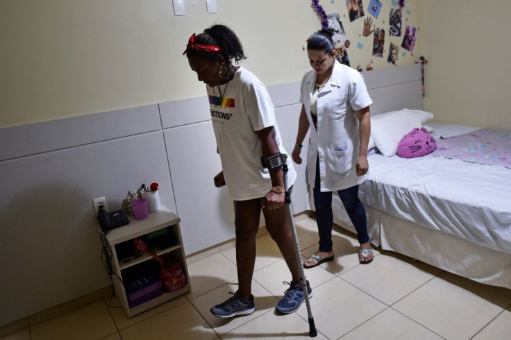 Talita Oliveira was pulled from the mud after the dam collapse and still needs crutches to walk; she takes 20 medications a day but has 'recovered well'