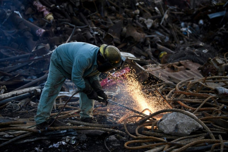 A worker at Josh Steel Company cuts scrapped steel rebar for recycling in North Braddock, Pennsylvania -- a key electoral state where the industry has had a far-reaching impact