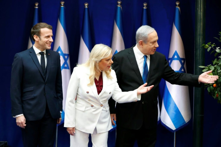 French President Emmanuel Macron (L) is welcomed by Israeli Prime Minister Benjamin Netanyahu (R) and his wife Sara (C) in Jerusalem on Wednesday
