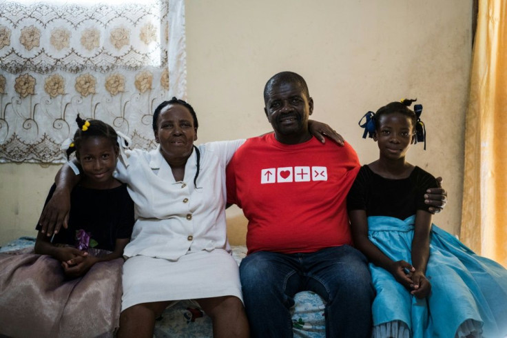 Andrea Cledion (2L) poses with her husband and their two foster children, who they consider to be their daughters