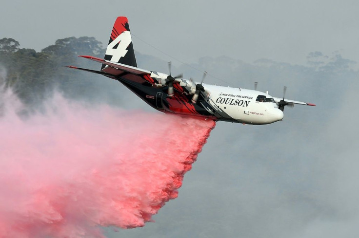 A C-130 Hercules plane from the New South Wales Rural Fire Service dropping fire retardent on bushfires