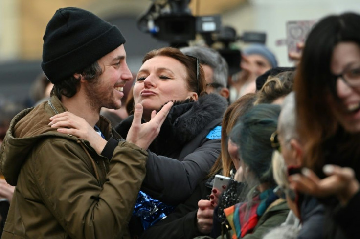 A woman kisses Mattia Santori , one of the founders of the anti-fascist 'Sardine Movement' during a rally this week in Bologna, the capital of Emilia Romagna