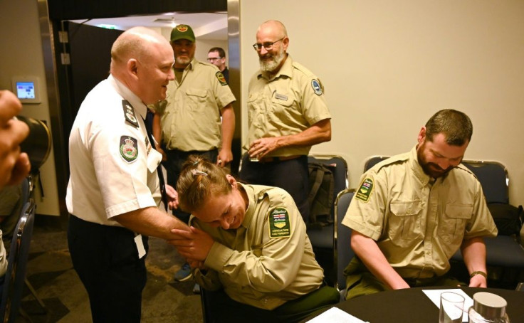 NSW Rural Fire Service Commissioner Shane Fitzsimmons (L) thanks firefighters at a farewell for 32 Americans and Canadians  who arrived in Australia before Christmas to help fight the blazes