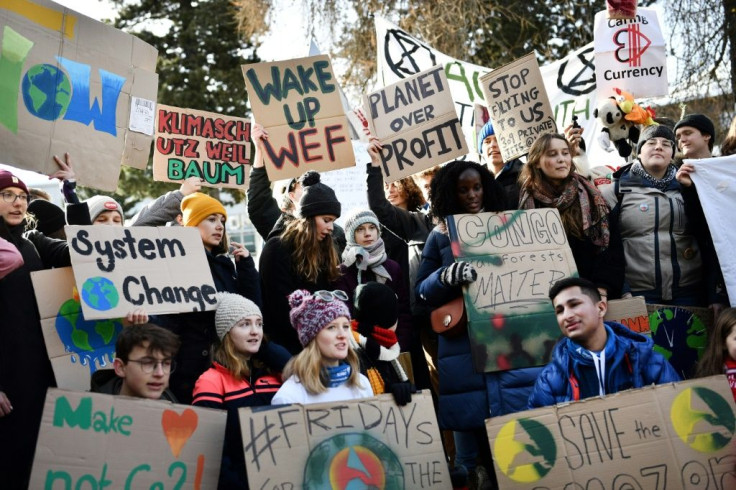 Swedish climate activist Greta Thunberg (C) marches during a "Fridays for future" youth demonstration in a street of Davos