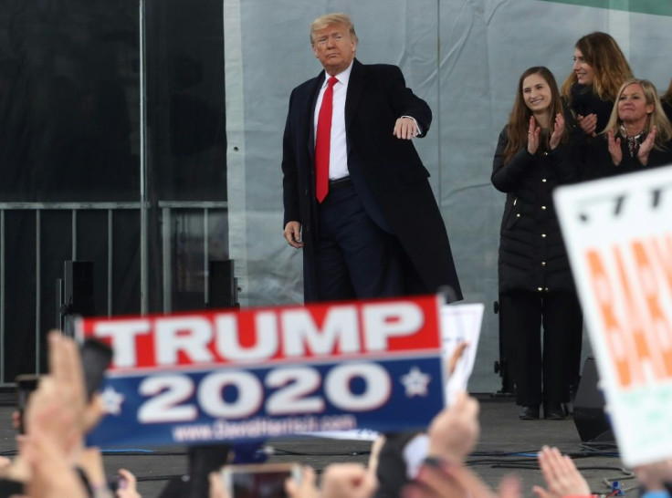 A Trump supporter holds a re-election sign as President Donald Trump leaves the anti-abortion "March for Life" rally