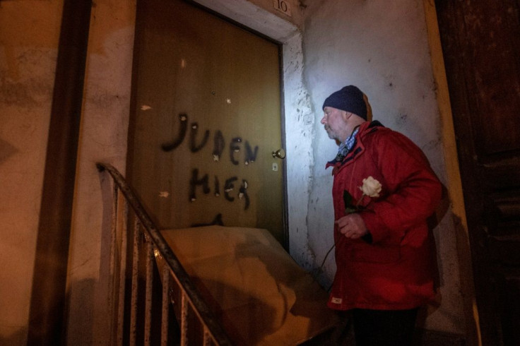 Aldo Rolfi, son of Italian writer Lidia Beccaria Rolfi (1925-1996), a former member of the Italian Resistance who was deported to Ravensbrueck concentration camp as a political prisoner, shows anti-Semitic tags written on his door to protesters
