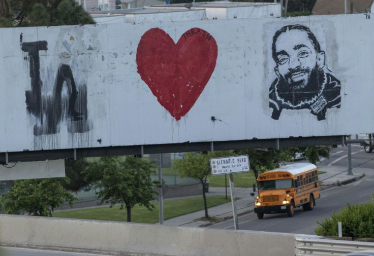 A mural along US Highway 101 honors slain rapper Nipsey Hussle, who is posthumously up for three Grammys