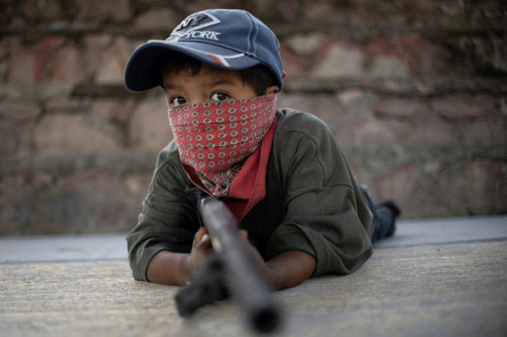 Children in Ayahualtempa train with rifles or makeshift guns to join the fight against drug cartels