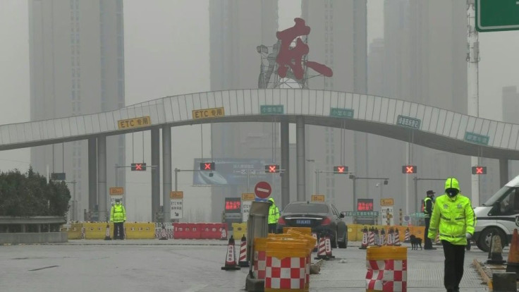 Police block roads into the Chinese city of Wuhan, which has been locked down in an unprecedented quarantine effort aimed at containing a deadly respiratory virus which has left at least 41 people dead