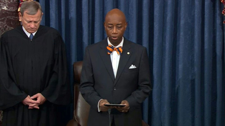 Senate chaplain Barry Black (R) reads the invocation as US Supreme Court Chief Justice John Roberts listens at the impeachment trial of President Donald Trump