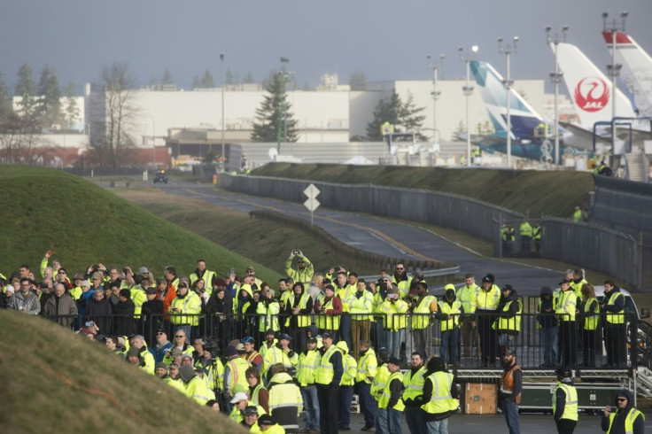 Boeing employees and others watch as a Boeing 777X airplane taxis before taking off on its inaugural flight at Paine Field in Everett, Washington in the United States on January 25, 2020
