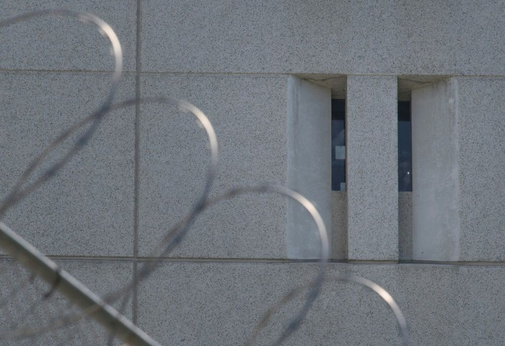 A detainee shines a torch from the main ICE detention center in downtown Los Angeles in  2019