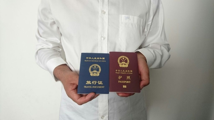 An unidentified Chinese Uighur man in the city of Medina holds his expired Chinese passport (red) and a one-way travel document (blue) issued in its place by the Chinese mission in Saudi Arabia