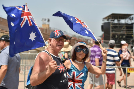 A couple wave flags to mark Australia Day in Sydney