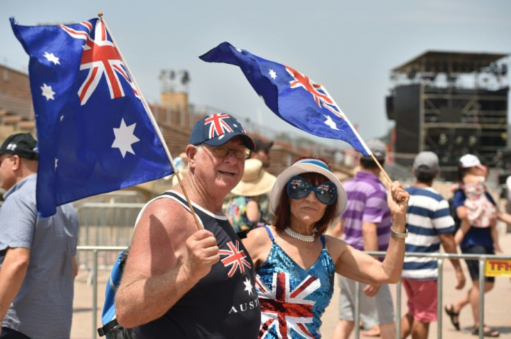 A couple wave flags to mark Australia Day in Sydney