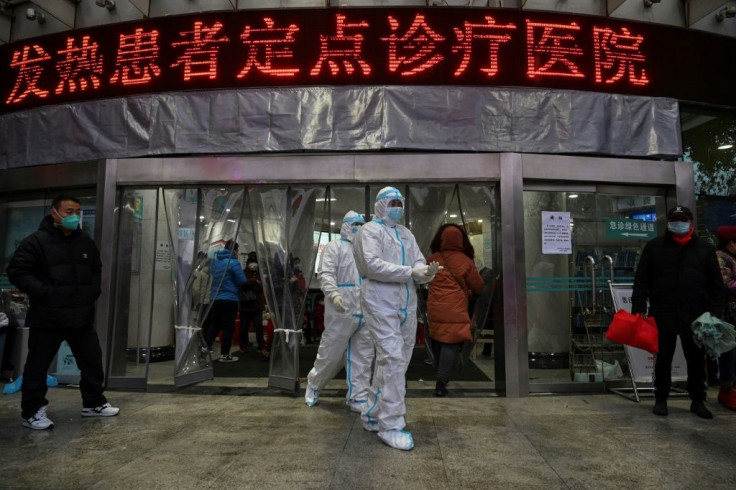 Medical staff outside  the Wuhan Red Cross Hospital, where resources are stretched to the limit