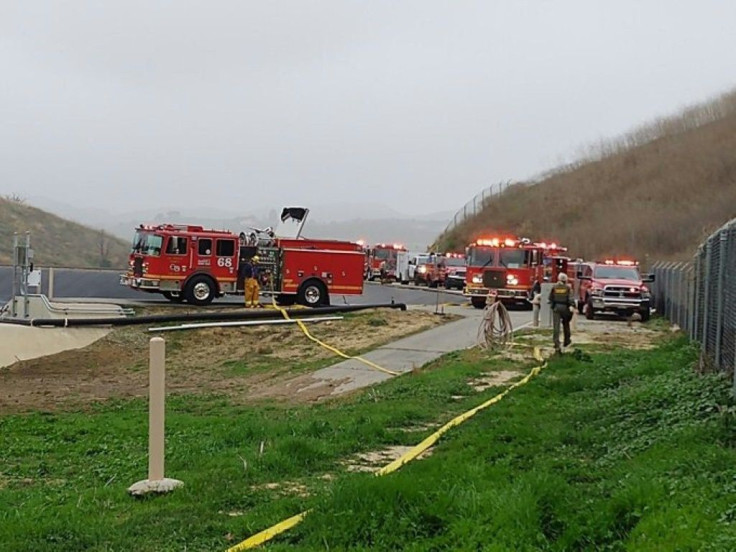 This handout photo obtained January 26, 2020,courtesy of the Los Angeles County Sheriff's Department, shows LA County Fire personel on the scene of a Helicopter crash in Calabasas, California.NBA legend Kobe Bryant died Sunday in a helicopter crash in sub