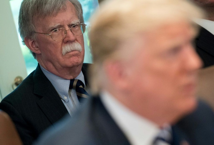 Trump's denial came after The New York Times reported that his former national security advisor John Bolton (L) says in his upcoming book that the president tied Ukraine aid to an investigation of his rivals