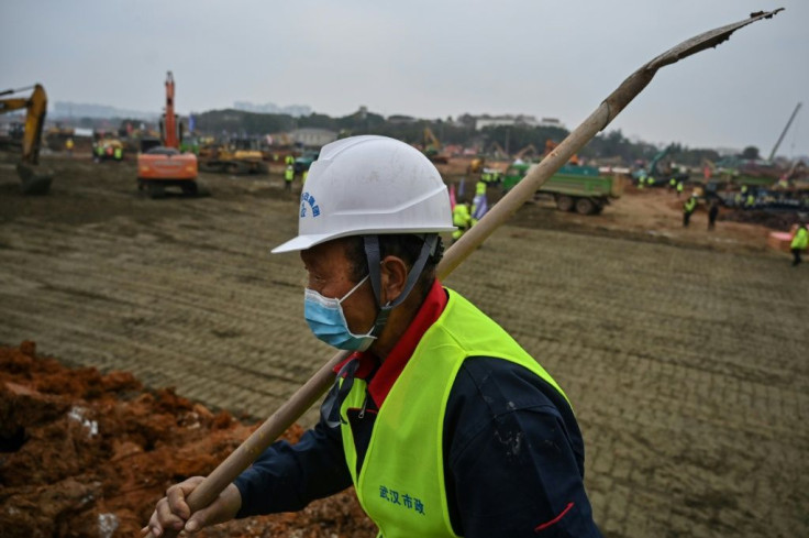 Construction workers at the sites of new hospitals in Wuhan are checked for fevers when they arrive and again during their breaks