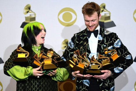 US singer-songwriter Billie Eilish (L) and her brother Finneas O'Connell cradle their trophies after scoring big at the 62nd annual Grammys