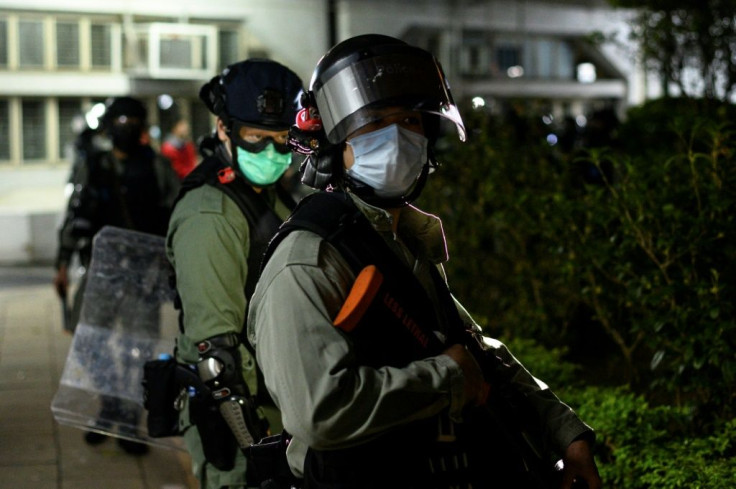 Police officers wearing face masks under their riot protection gear